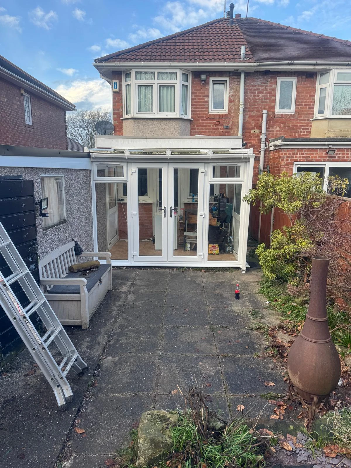 A house with a large patio and a white door.